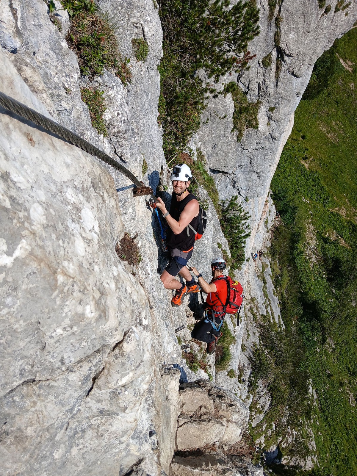 Zwei Klettersteiggeher in der senkrechten Wand des Donnerkogels